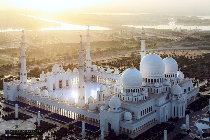 Marvel at the stunning architecture of Sheikh Zayed Mosque an iconic symbol of Abu Dhabi surrounded by beautifully landscaped grounds and reflecting pools perfect for memorable photos.